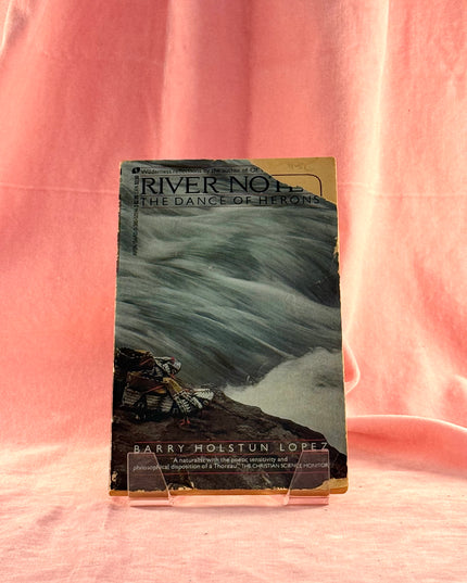 Book titled 'River No. 1: The Dance of Herons' by Barry Molstun Lopez on a pink background