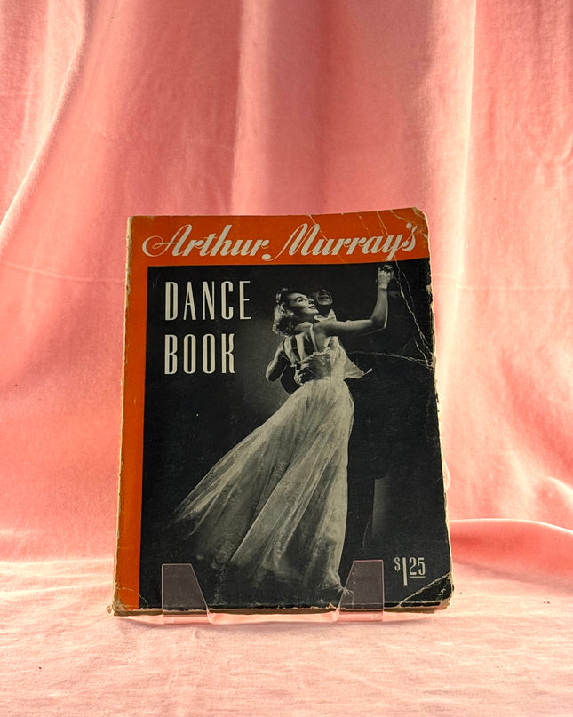 Vintage 'Arthur Murray's Dance Book' on a pink background