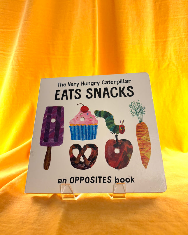 The Very Hungry Caterpillar Eats Snacks: An Opposites Book (The World of Eric Carle) by Eric Carle