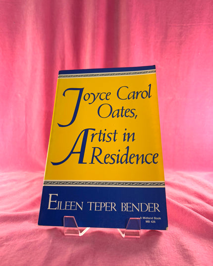 Book titled 'Joyce Carol Oates, ' by Eileen Teper Bender on a pink background