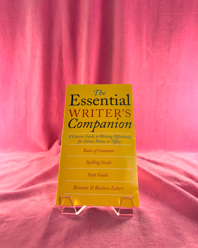 Yellow book titled 'The Essential Writer's Companion' on a pink fabric background