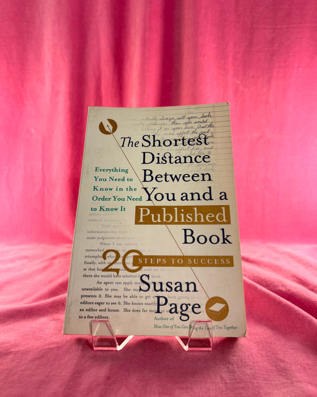 Book titled 'The Shortest Distance Between You and a Published Book' by Susan Page on a pink background