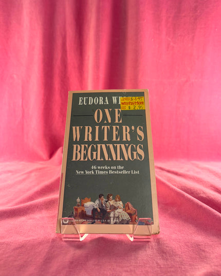 Book titled 'One Writer's Beginnings' by Eudora Welty on a pink fabric background