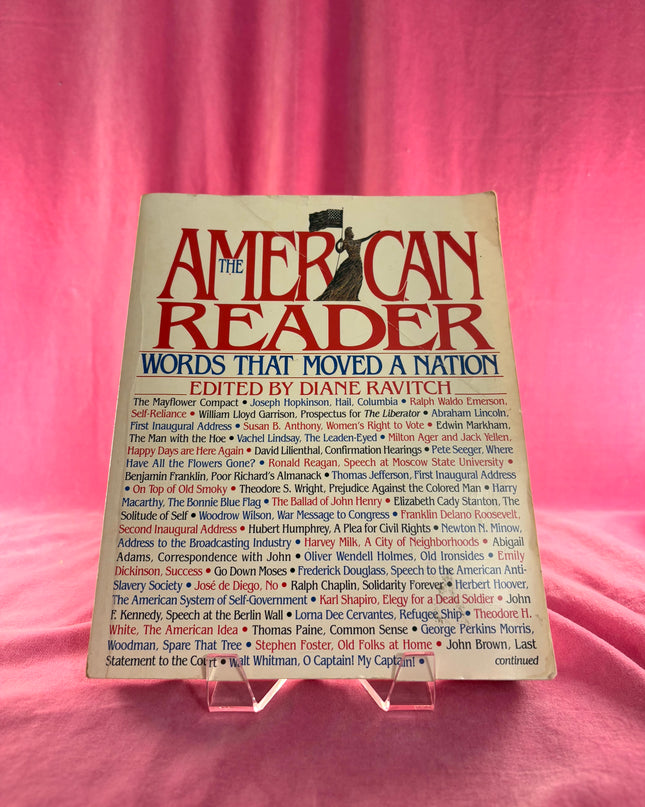 Book titled 'The American Reader: Words That Moved a Nation' edited by Diane Ravitch on a pink background