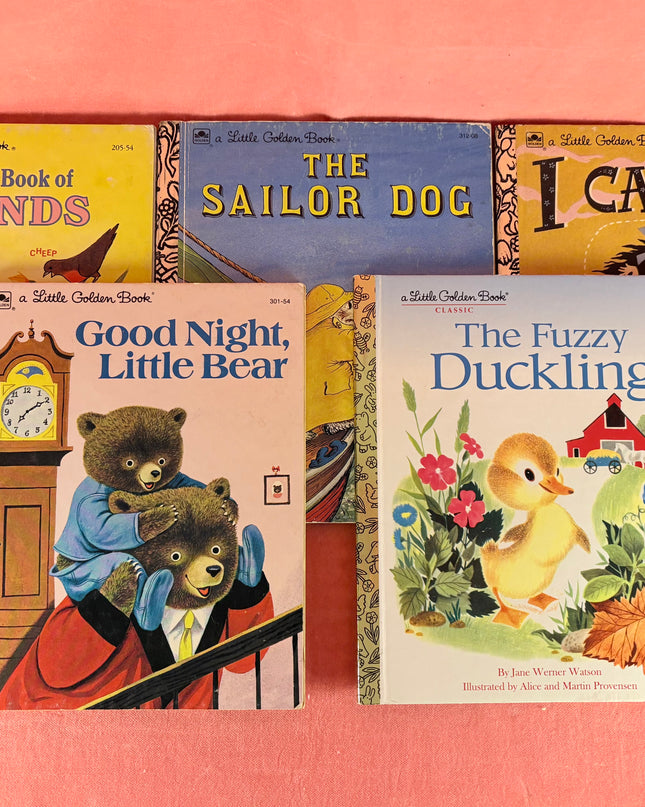 Collection of children's books on a pink background