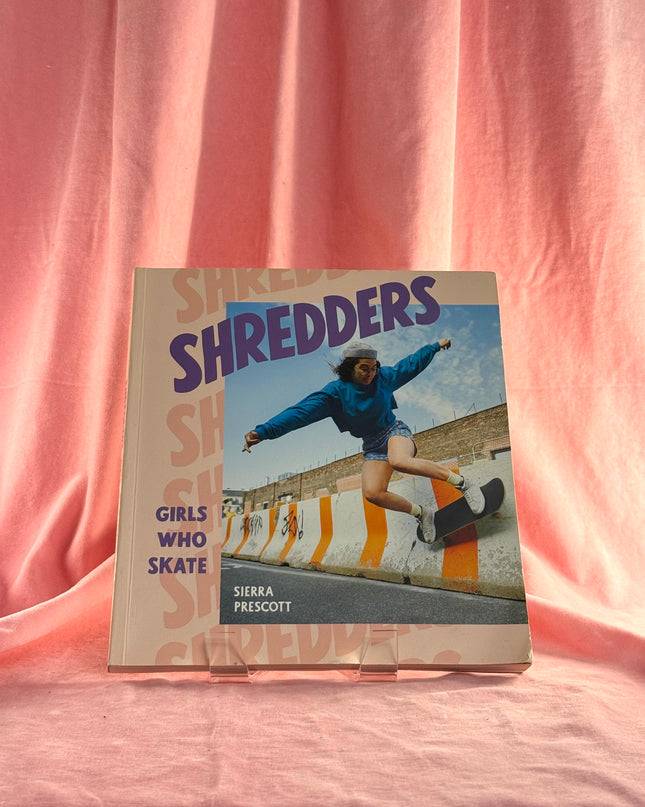 Book titled 'Shredders' on a pink background