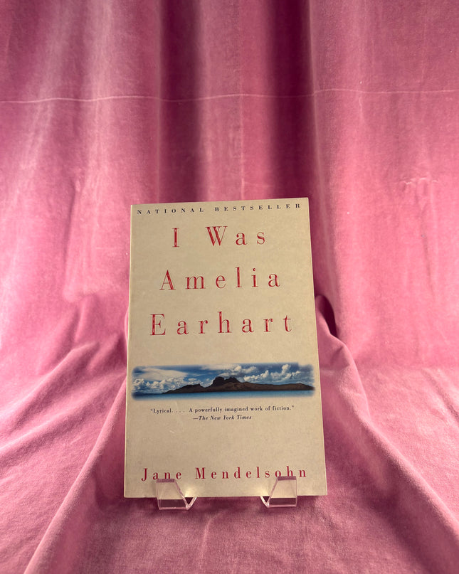 Book titled 'I Was Amelia Earhart' by Jane Mendelsohn on a pink fabric background