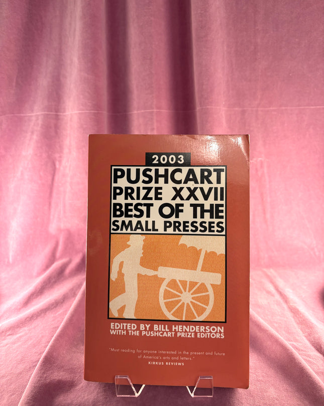 Book titled '2003 Pushcart Prize XXVII Best of the Small Presses' on a pink fabric background