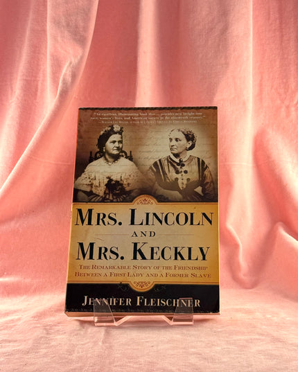 Book titled 'Mrs. Lincoln and Mrs. Keckly' on a pink fabric background
