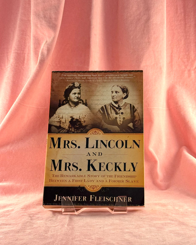 Book titled 'Mrs. Lincoln and Mrs. Keckly' on a pink fabric background