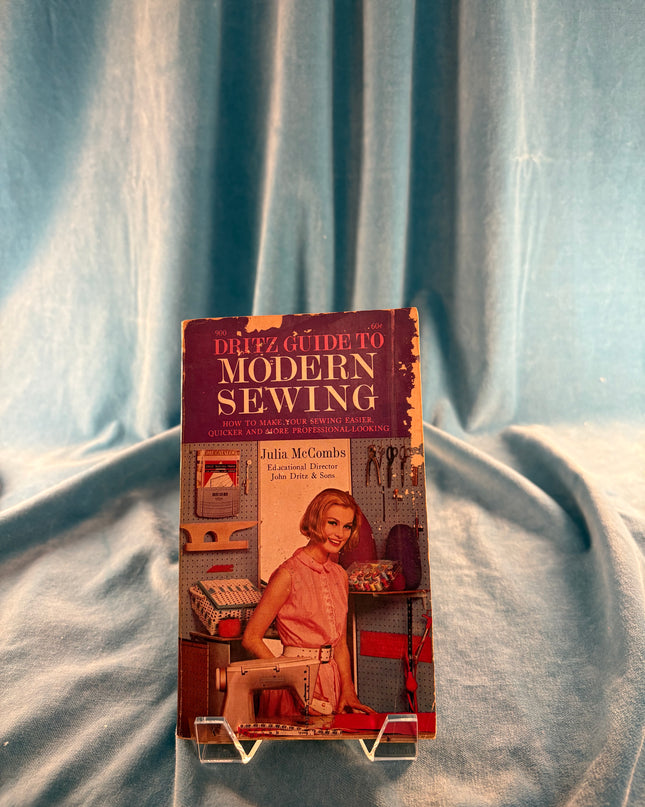 Book titled 'Modern Sewing' on a textured fabric background