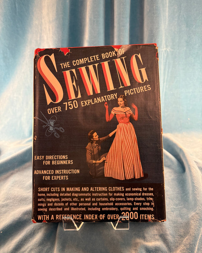 Vintage book titled 'The Complete Book of Swing Sewing' on a textured surface
