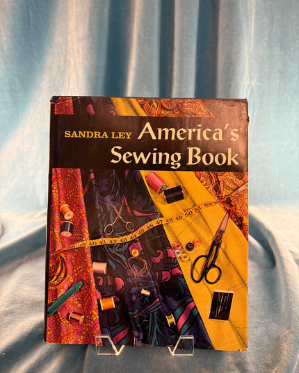 Book titled 'America's Sewing Book' by Sandra Levy on a textured surface