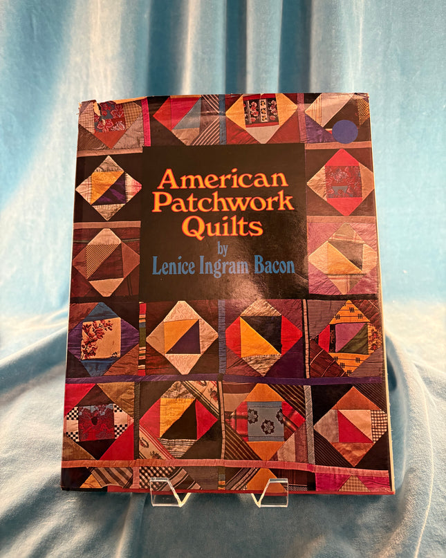 Book titled 'American Patchwork Quilts' by Lenna Ingram Bacon on a textured fabric background