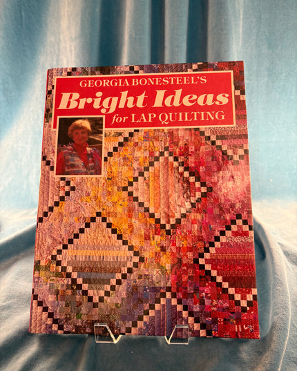Book titled 'Bright Ideas for Lap Quilting' by Georgie Boneitel on a textured surface