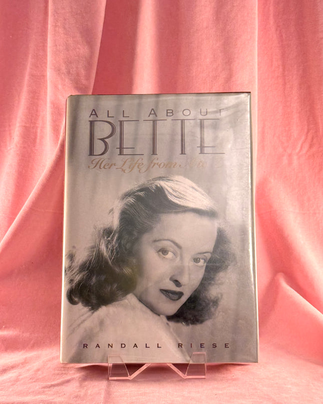Book titled 'All About Bette' on a pink fabric background