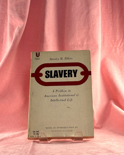 Book titled 'Slavery' by Stanley M. Elkins on a pink fabric background
