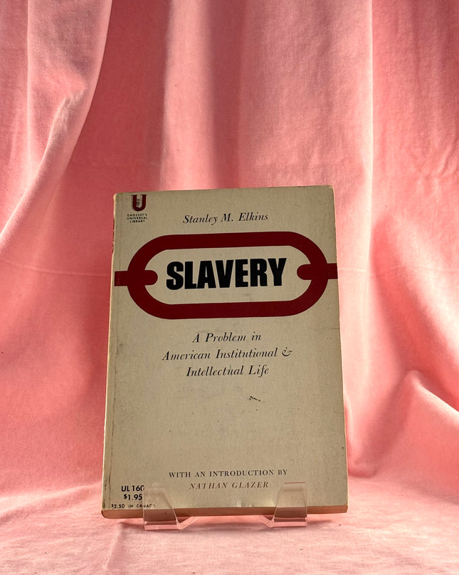 Book titled 'Slavery' by Stanley M. Elkins on a pink fabric background