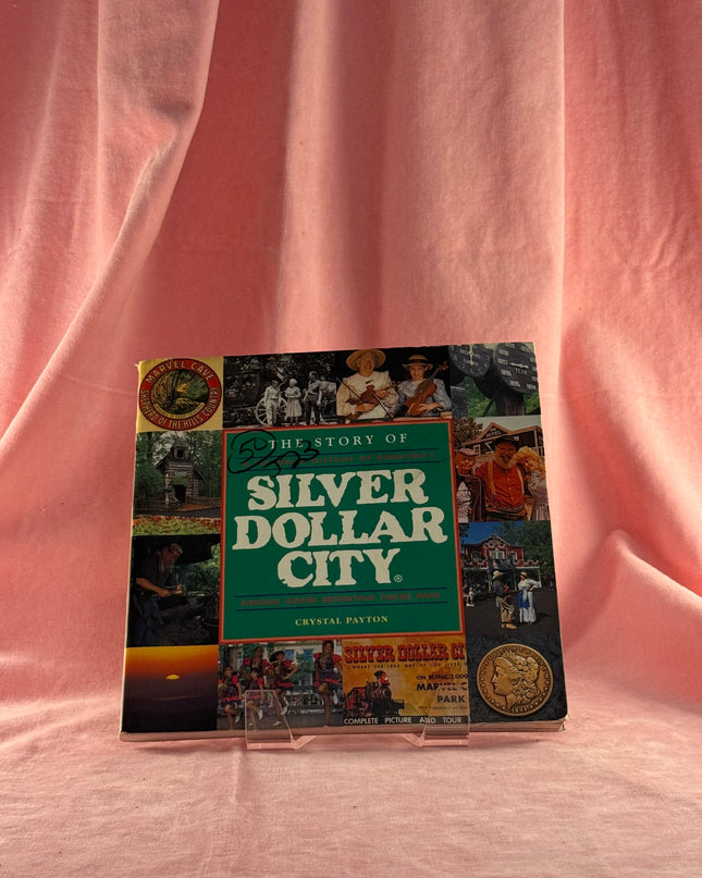 Book titled 'Silver Dollar City' on a pink fabric background