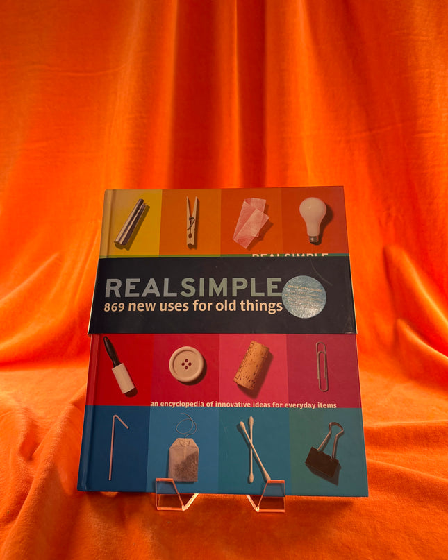 Book titled 'REAL SIMPLE 869 new uses for old things' on an orange fabric background