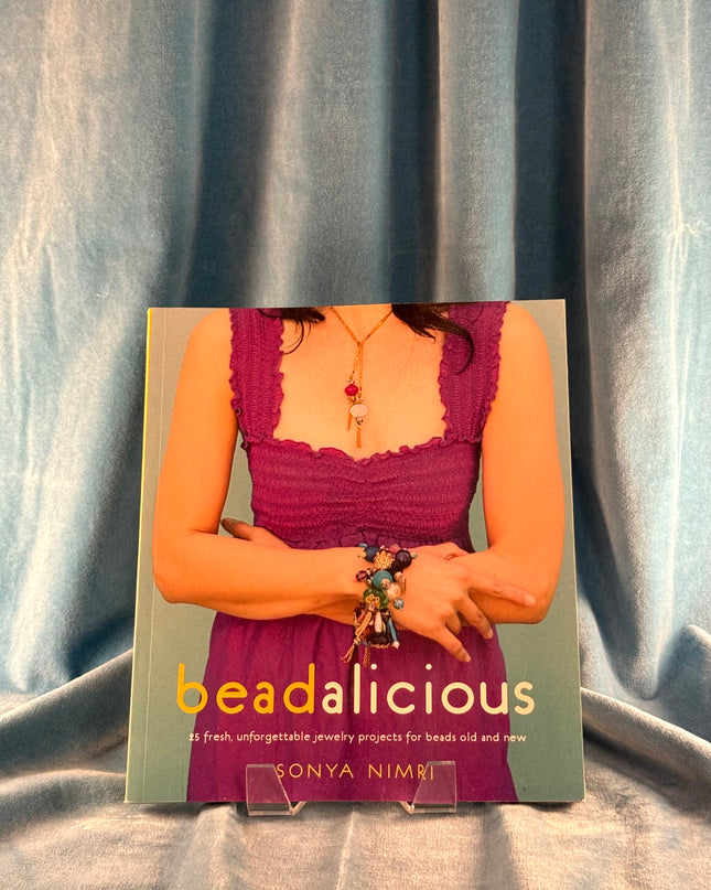 Book titled 'beadalicious' by Sonya Nimri on a textured fabric background