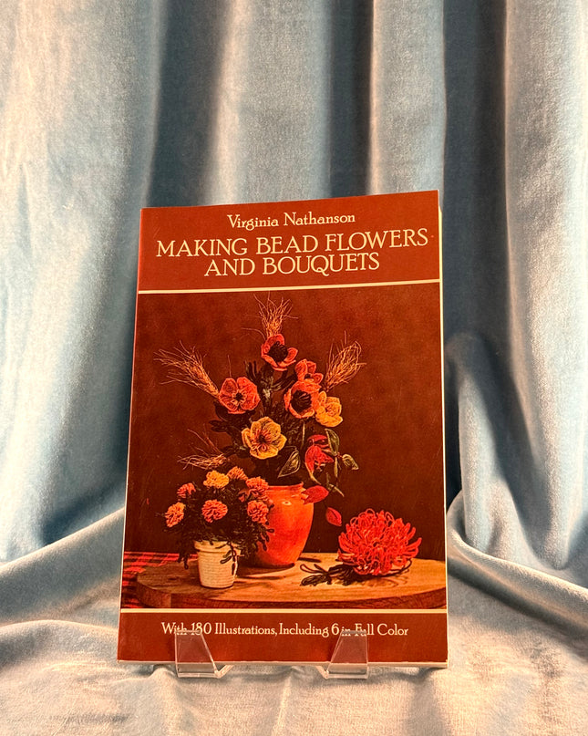 Book titled 'Making Bead Flowers and Bouquets' by Virginia Nathanson on a gray fabric background