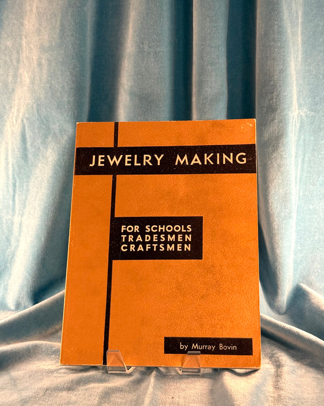 Book titled 'Jewelry Making for Schools, Tradesmen, Craftsmen' by Murray Bovin on a gray fabric background