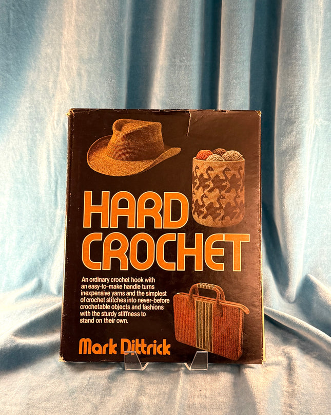 Book titled 'Hard Crochet' by Mark Dittrick on a light blue fabric background
