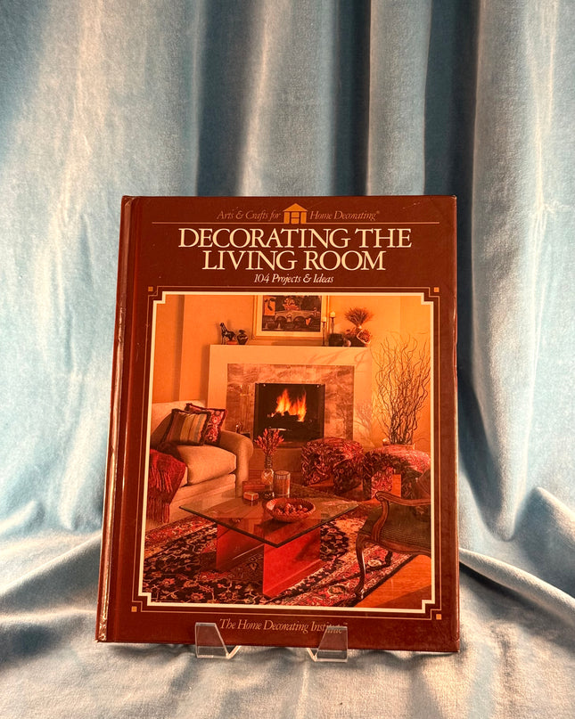 Book titled 'Decorating the Living Room' on a fabric background