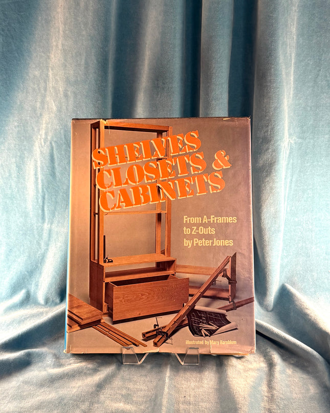 Book titled 'Shelves & Closets & Cabinets' by Peter Jones on a textured fabric background