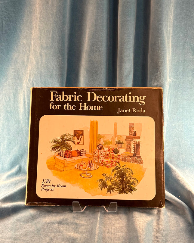 Book titled 'Fabric Decorating for the Home' by Janet Roda on a blue fabric background