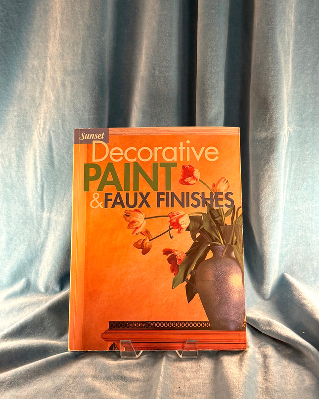 Book titled 'Decorative Paint & Faux Finishes' on a gray fabric background