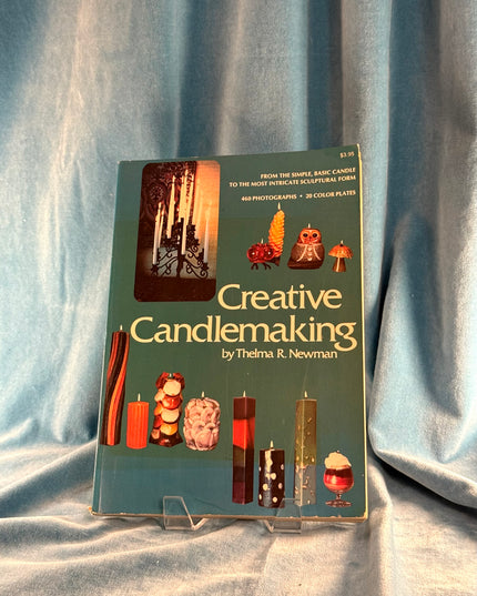 Book titled 'Creative Candlemaking' by Thelma R. Newman on a gray fabric background