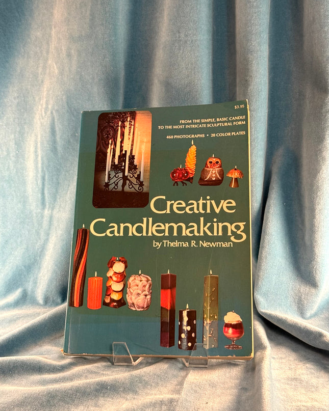 Book titled 'Creative Candlemaking' by Thelma R. Newman on a gray fabric background