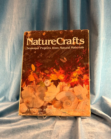 Book titled 'Nature Crafts' on a textured fabric background