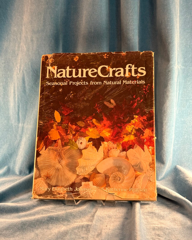 Book titled 'Nature Crafts' on a textured fabric background