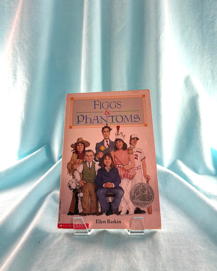 Book titled 'Figgs & Phantoms' by Ellen Raskin on a light blue fabric background