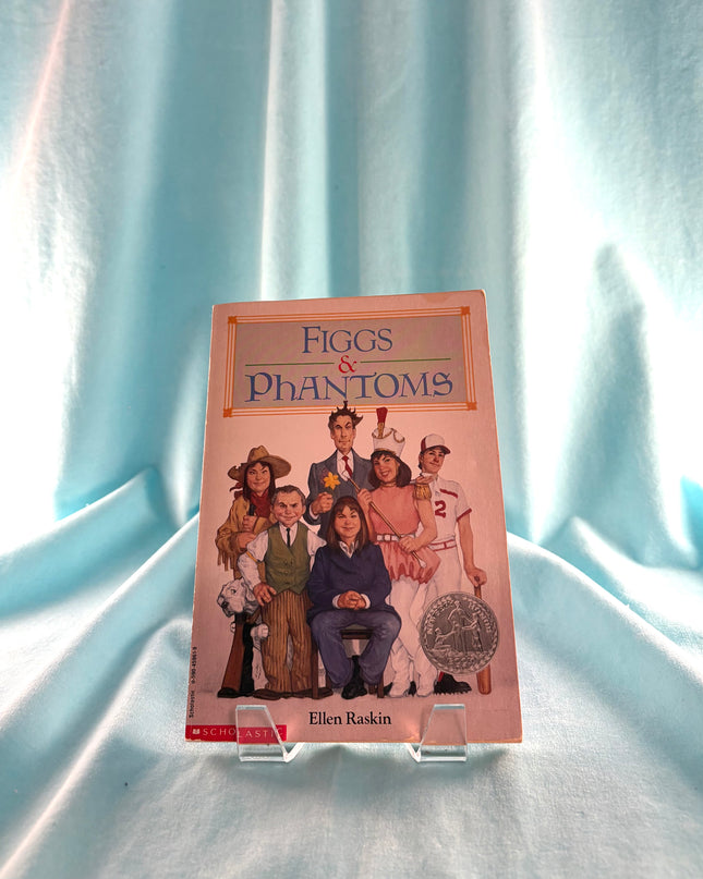 Book titled 'Figgs & Phantoms' by Ellen Raskin on a light blue fabric background