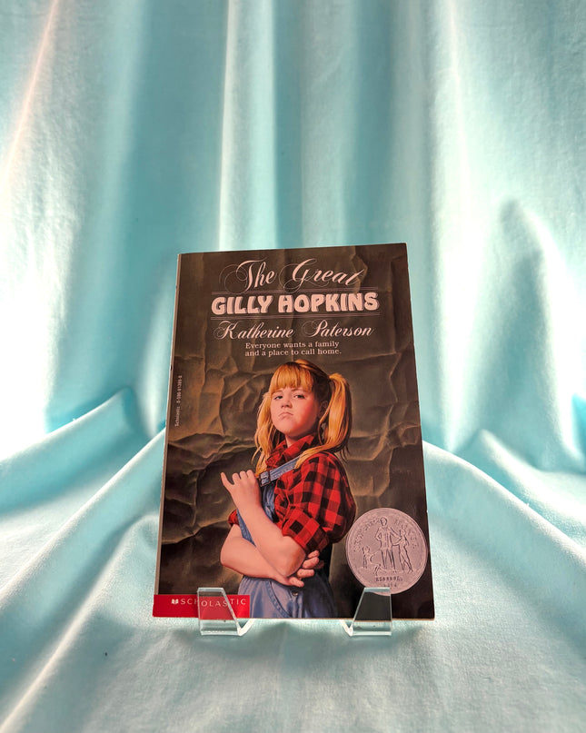 Book titled 'The Great Gilly Hopkins' by Katherine Paterson on a light blue fabric background