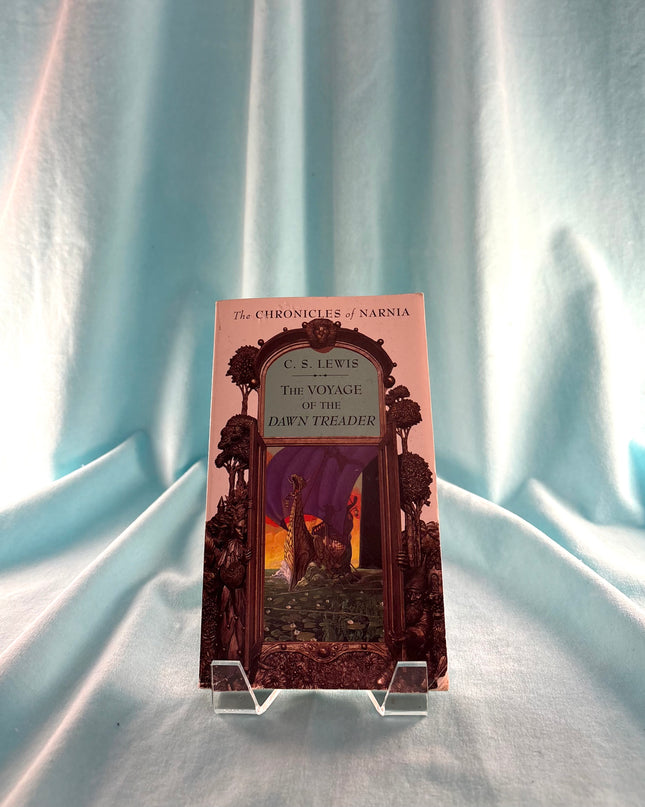 Book titled 'The Voyage of the Dawn Treader' by C.S. Lewis on a light blue fabric background frame
