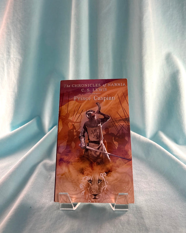 Bookend with 'The Chronicles of Narnia' horn design on a light blue fabric background