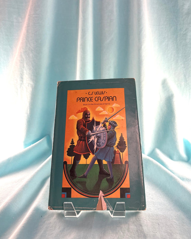 Book cover of 'Prince Caspian' by C.S. Lewis on a light blue fabric background