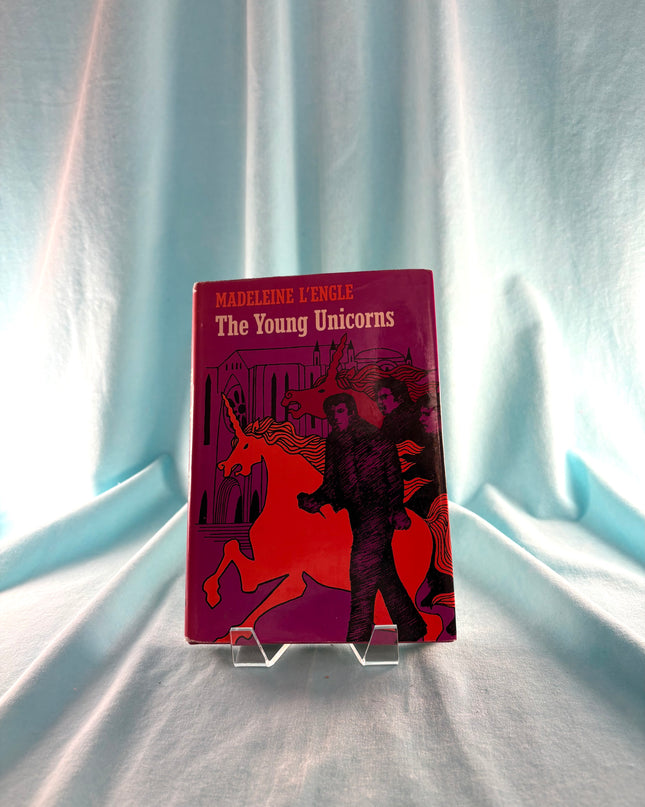 Book titled 'The Young Unicorns' by Madeleine L'Engle on a white fabric background