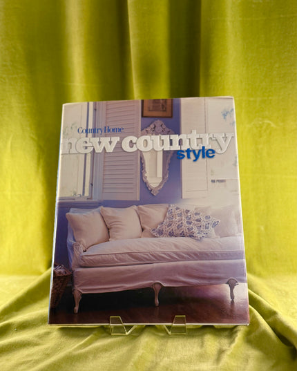 Book titled 'New Country Style' on a green fabric background