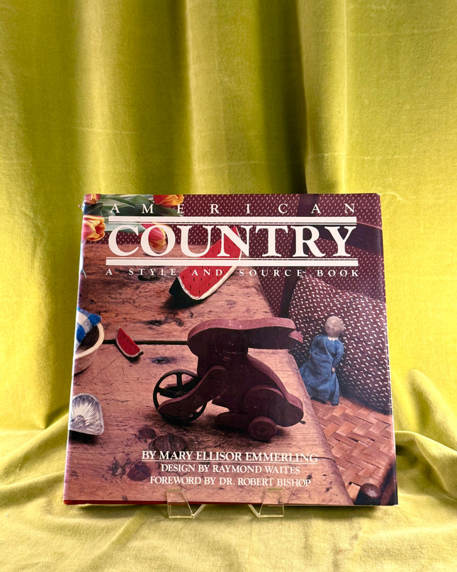 Book titled 'American Country: A Style and Source Book' on a yellow fabric background