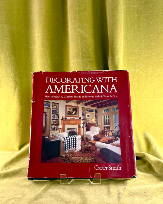 Book titled 'Decorating with Americana' by Carter Smith on a yellow fabric background
