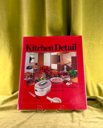 Red book titled 'Kitchen Detail' on a yellow fabric background