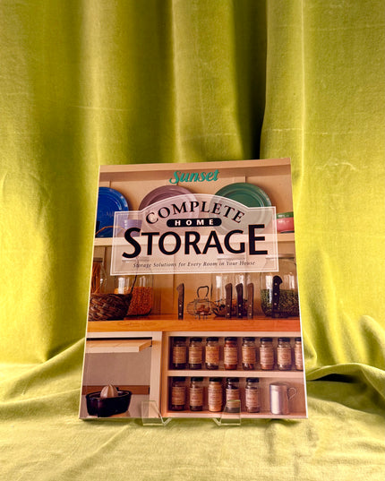 Sunset Complete Home Storage book on a green fabric background