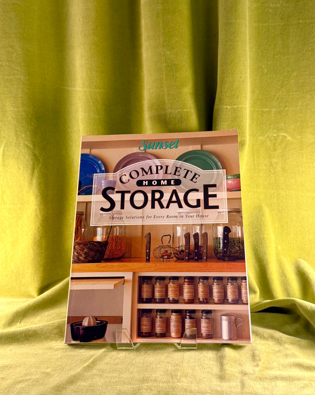 Sunset Complete Home Storage book on a green fabric background