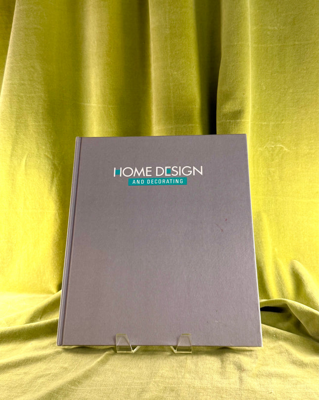 Book titled 'Home Design and Decorating' on a yellow fabric background